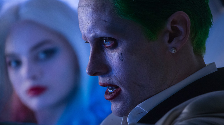 The Joker in profile with Harley behind him in Suicide Squad 2016