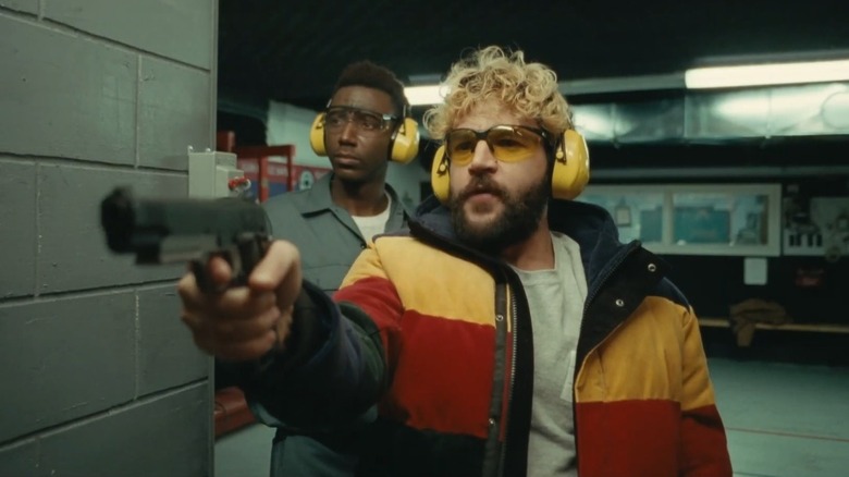 Christopher Abbott and Jerrod Carmichael with guns