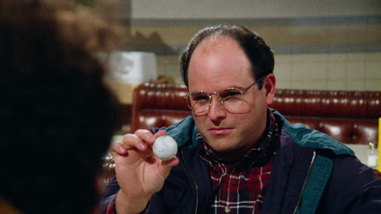 George Costanza showing a golf ball to everyone in Seinfeld