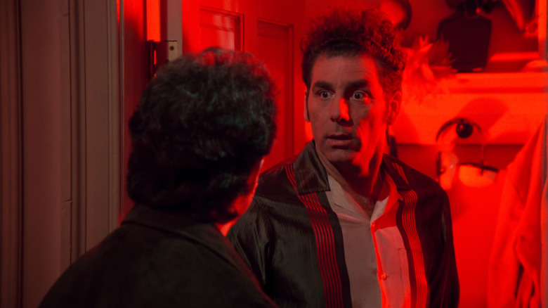 Seinfeld, Jerry talking to Kramer by his apartment door; Kramer's apartment is bathed in red light