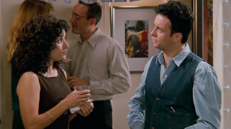 Julia Louis-Dreyfus as Elaine and Kevin McDonald as Denim Vest/Steve having a conversation on Seinfeld