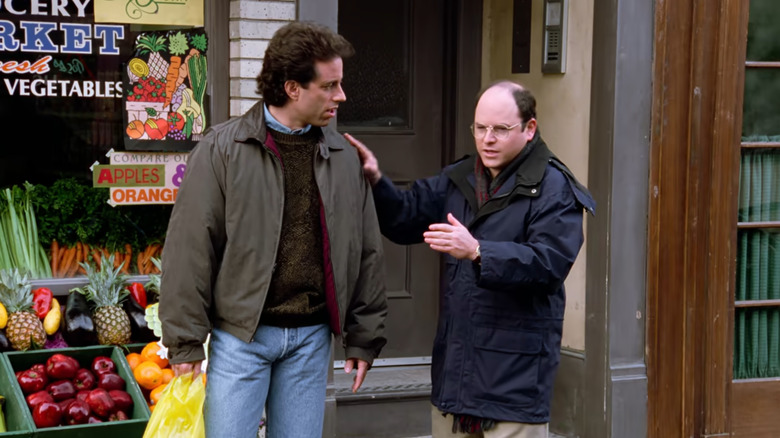 Jerry Seinfeld as Jerry and Jason Alexander as George standing outside a food store on Seinfeld