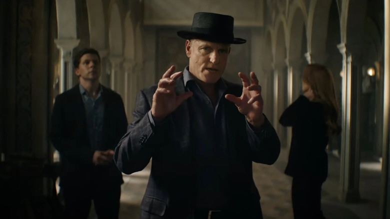 Merritt in the middle of a large room looking smug in Now You See Me: Now You Don't