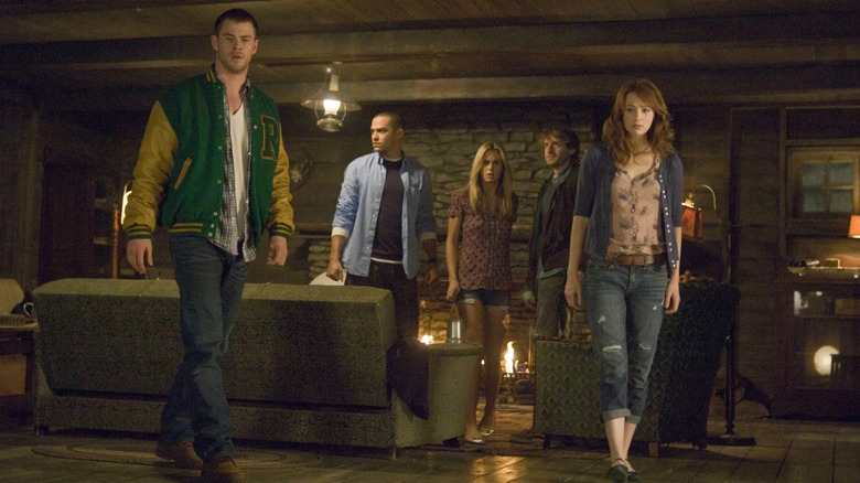 Curt Holden Jules Marty and Dana in the cabin looking scared in The Cabin in the Woods