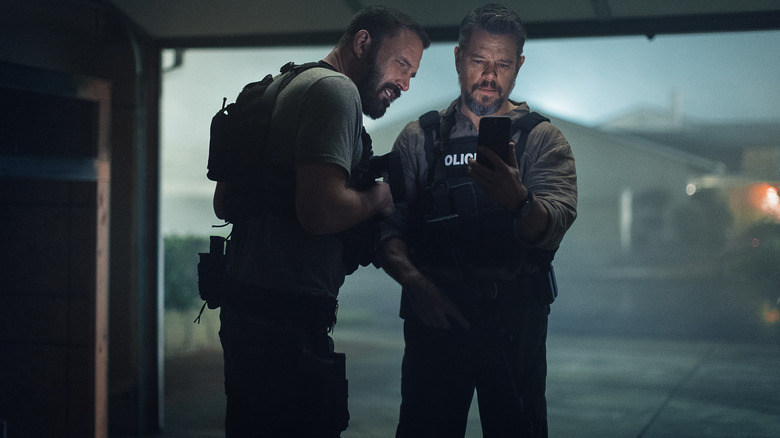 Dumars and Byrne Facetiming a cartel leader while standing in a garage in The Rip