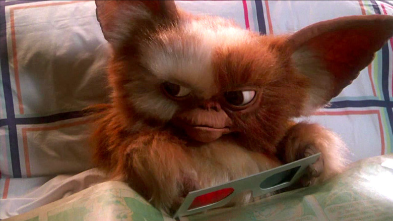 Gizmo looks angry while sitting in bed in Gremlins