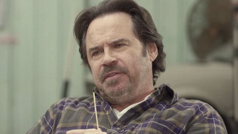 Dennis Miller as Zander Kelly sitting outside in Joe Dirt 2: Beauitful Loser