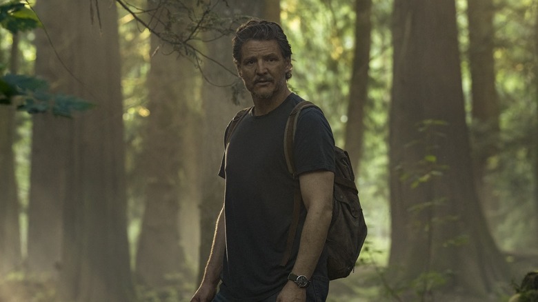 Joel looking anxious in the woods on The Last of Us