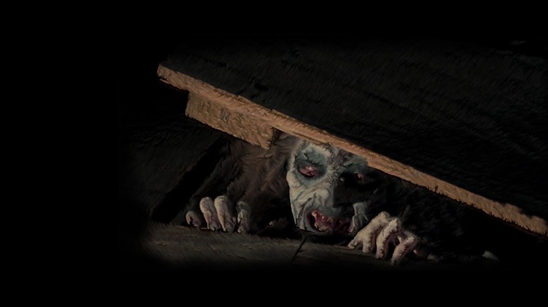 A demonically possessed woman peeks out of the cellar