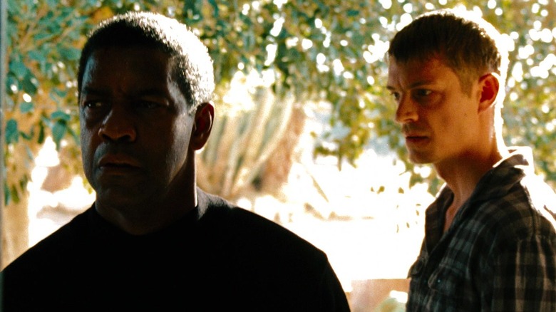 Joel Kinnaman's Keller watches as Denzel Washington's Tobin Frost walks past in Safe House