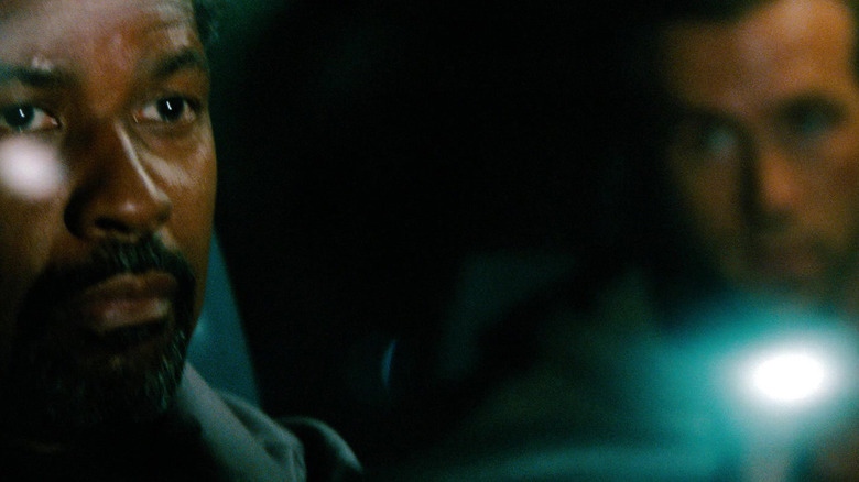 Denzel Washington's Tobin Frost is seen in the foreground with Ryan Reynolds' Matt Weston in the background in Safe House.jpg