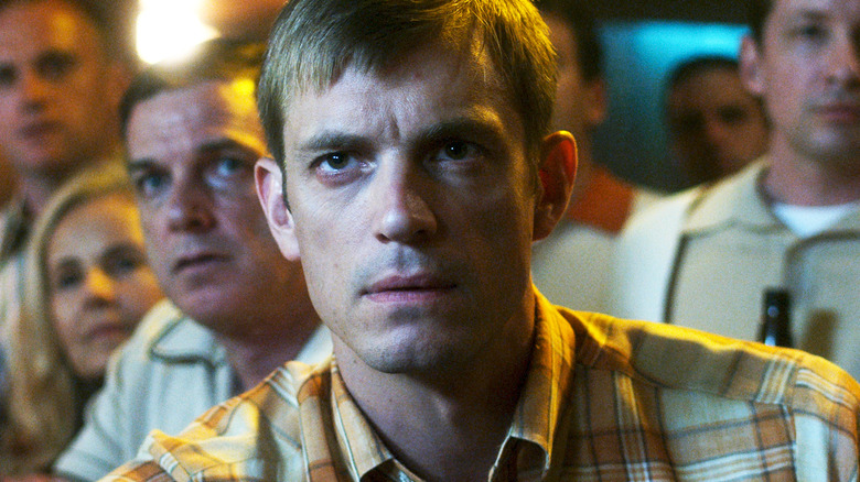 Joel Kinnaman's Edward Baldwin is seen in closeup as he sits in a bar in For All Mankind