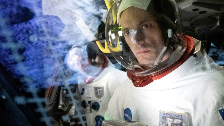 Joel Kinnaman's Edward Baldwin sits at a control panel in a space suit in For All Mankind