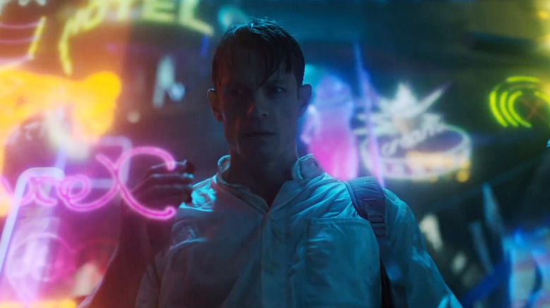 Joel Kinnaman's Takeshi "Tak" Kovacs stands amid a flurry of neon lights in Altered Carbon