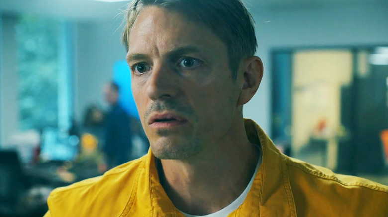 Joel Kinnaman's Rick Flag Jr. stands in an office in Peacemaker.jpg