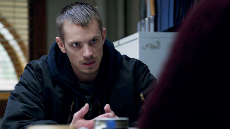 Joel Kinnaman's Stephen Holder sits at a table opposite Mireille Enos' Sarah Linden in The Killing