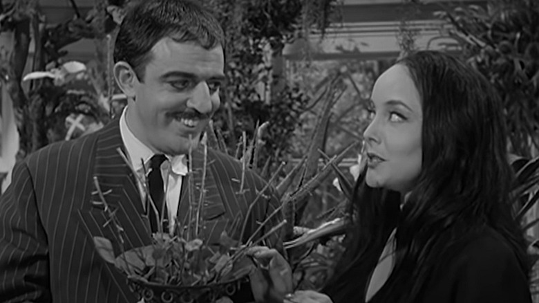 Carolyn Jones and John Astin converse on The Addams Family