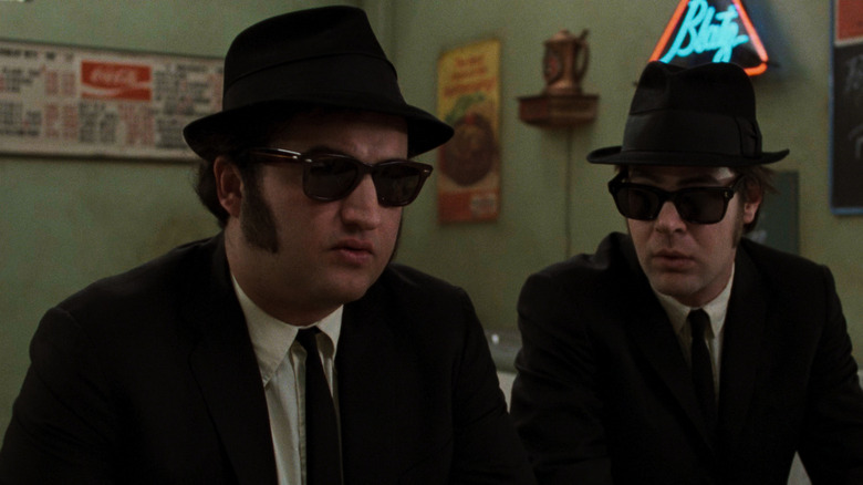 John Belloshi and Dan Icroid in black suits, shadows and trilogy as a Blues brothers in the movie of the same name.