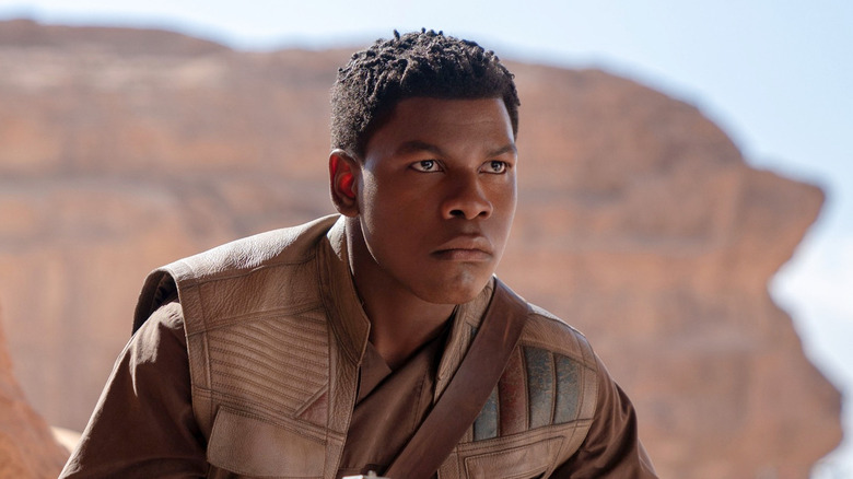 John Boyega as Finn wearing a brown jacket and looking angry in Star Wars: The Rise of Skywalker