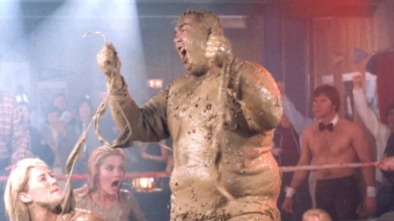 John Candy turns the table on his mud wrestling opponents as Dewey "Ox" Oxberger in Stripes