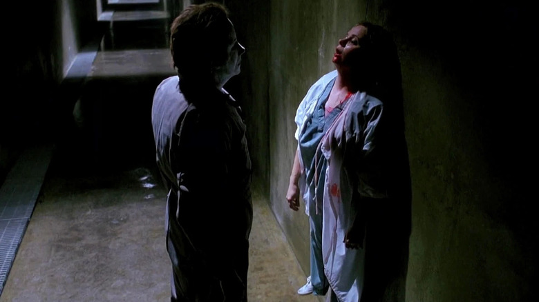 Michael Myers stabbing a woman to a wall in Halloween: The Curse of Michael Myers