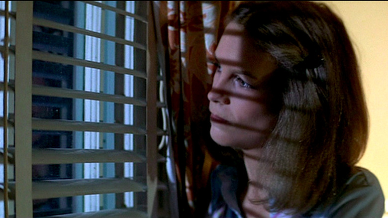 Jamie Lee Curtis looks out the window in Halloween