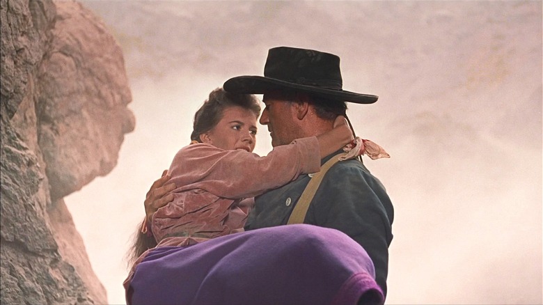 John Wayne holding Natalie Wood