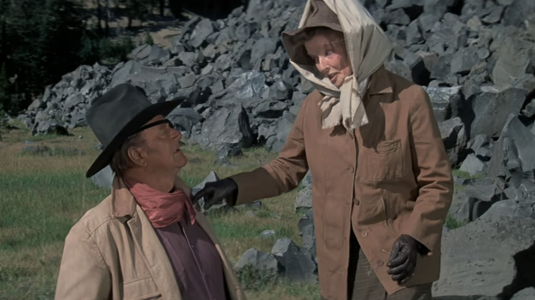 John Wayne's Rooster Cogburn looks up at Katharine Hepburn's Miss Eula Goodnight in Rooster Cogburn