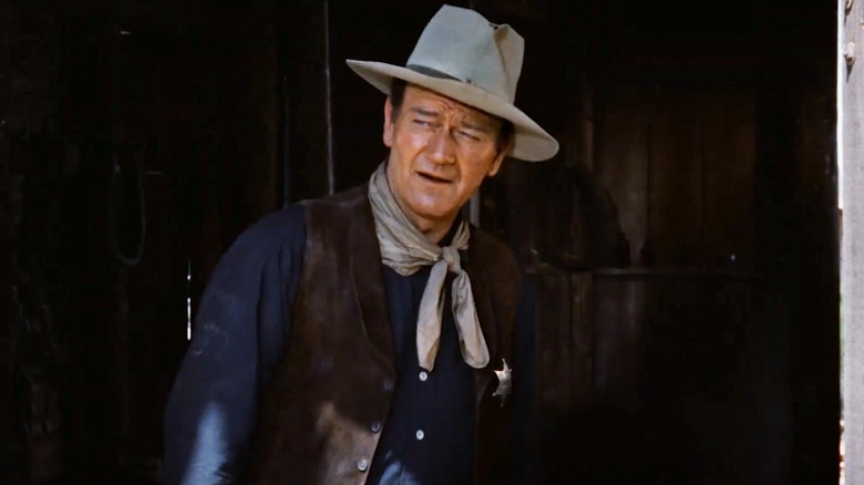 John Wayne as Sheriff John T. Chance stands in shadow in Rio Bravo