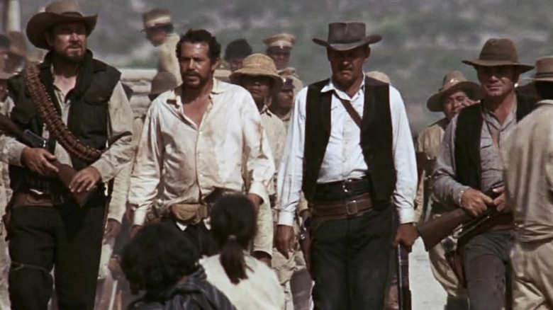 William Holden as Pike Bishop standing among his compatriots in The Wild Bunch