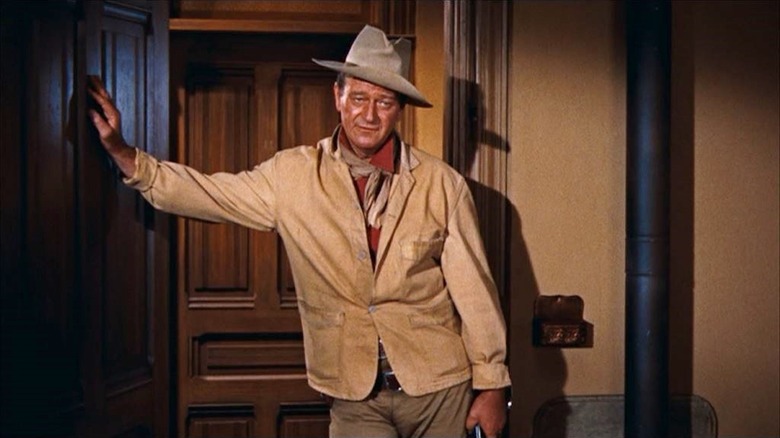 John Wayne stands at an entrance like John T. Chance in Rio Bravo