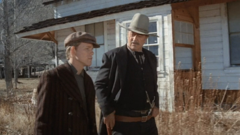 John Wayne's J B Books walks alongside Ron Howard's Gillom Rogers in The Shootist
