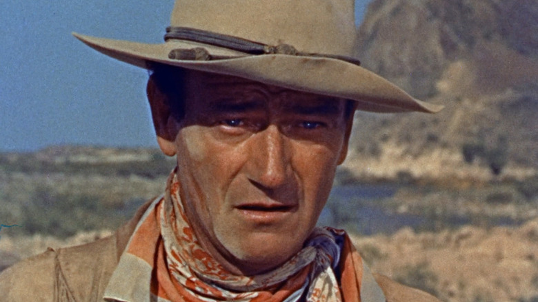 John Wayne's Hondo Lane is seen in closeup standing on the open range in Hondo
