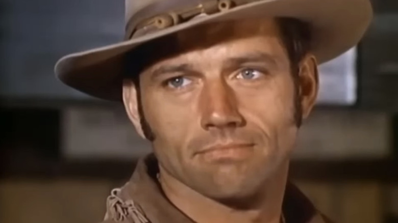 Ralph Taeger's Hondo Lane smiles in closeup in Hondo