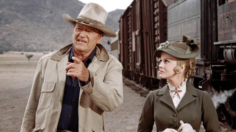 John Wayne and Ann Margaret by the train in The Train Robbers
