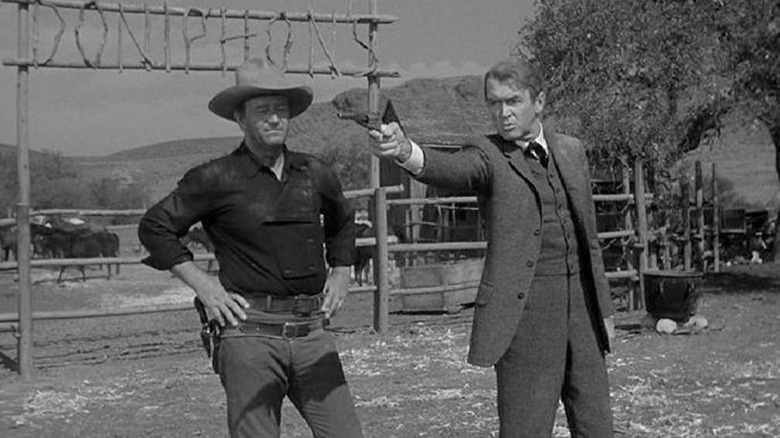 Tom Doniphon (John Wayne) shows Ransom Stoddard (James Stewart) how to shoot a gun in The Man Who Shot Liberty Valance