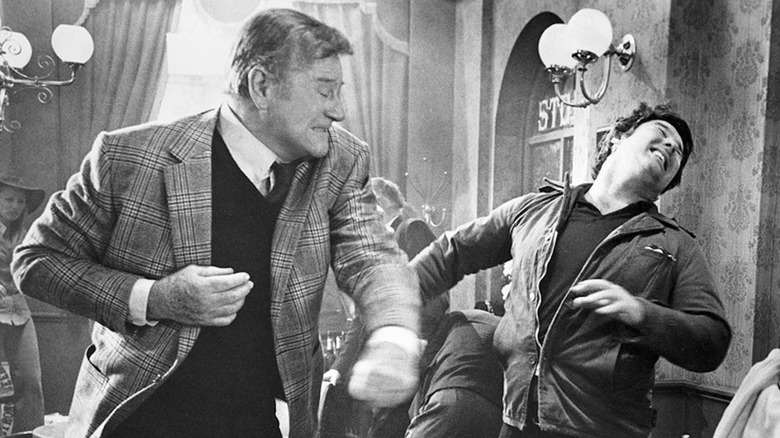 John Wayne, as Lieutenant James Praneghan, shines a thug with his liver fists in Braneghan