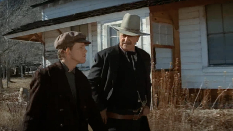 Shootist Wayne walking young man