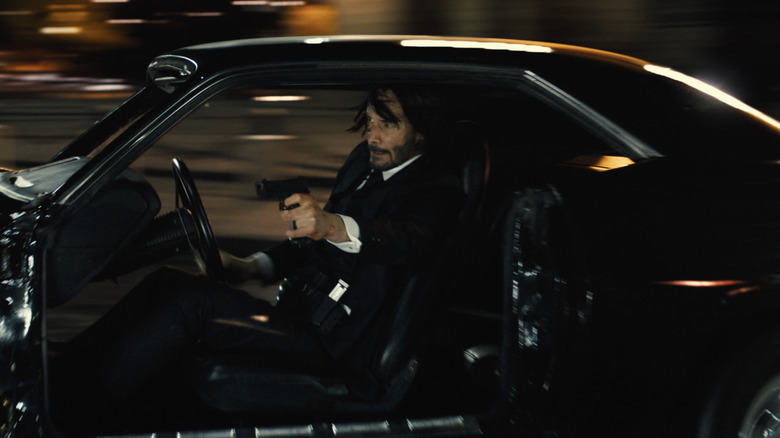Keanu Reeves in car in John Wick 4