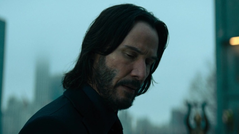 John Wake looks from Keanu Reeves to his shoulder at John Wick Chapter 4. JPG