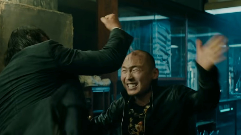 John Wick driving a knife into a man's skull