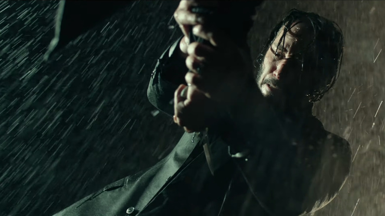 John grabbing Viggo's knife and pointing toward himself in John Wick