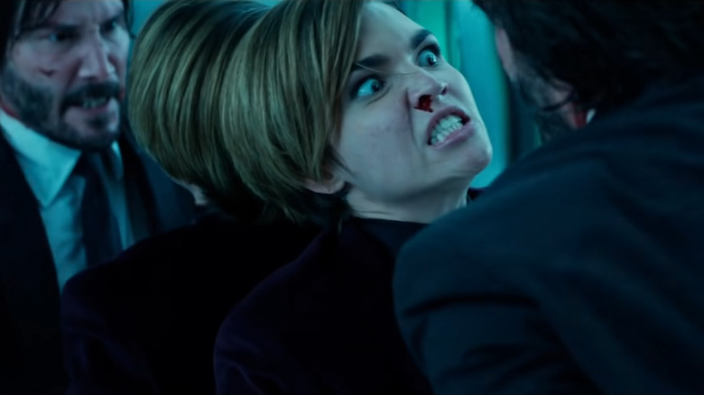 Ares pinned against the mirror by John in John Wick: Chapter 2