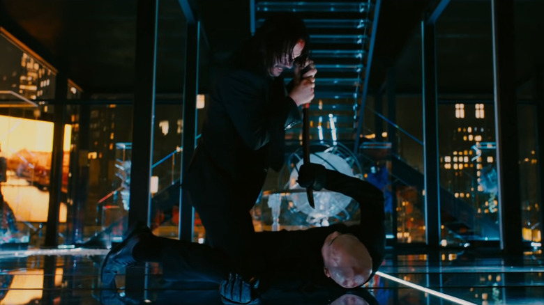 John pressing a sword toward Zero's chest in mirrored room in John Wick: Chapter 3