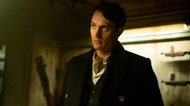 Colin Woodell as Winston standing in a room full of guns in The Continental: From the World of John Wick