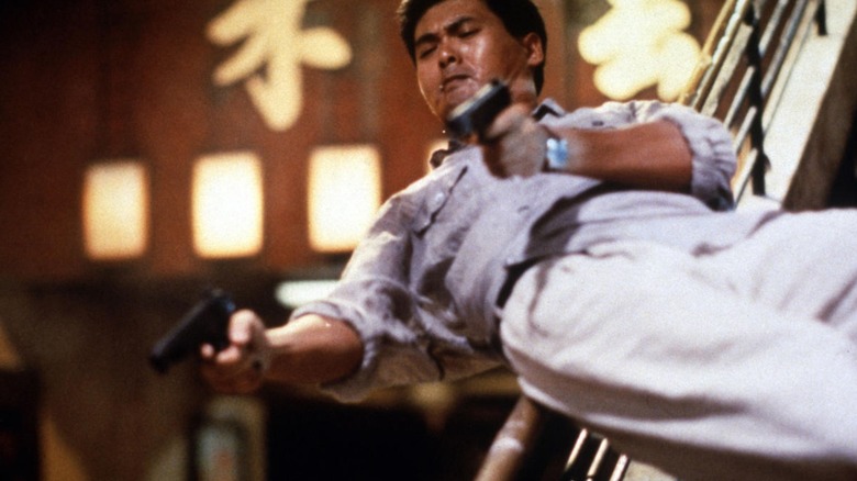 Inspector Tequila leaps through the air with dual guans in Hard Boiled