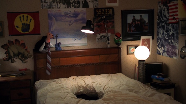 Glen's bed with a hole in A Nightmare on Elm Street