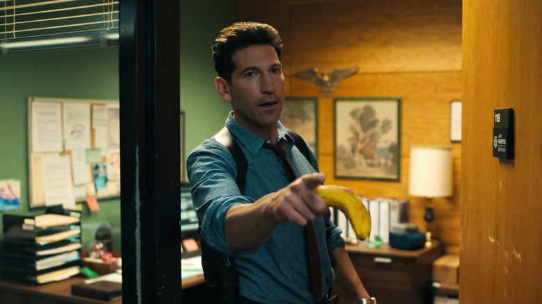 Jack in his office door holding a banana in His & Hers