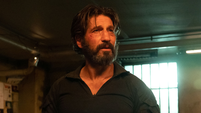 Jon Bernthal as Frank Castle in his underground hideout with a beard in Daredevil: Born Again