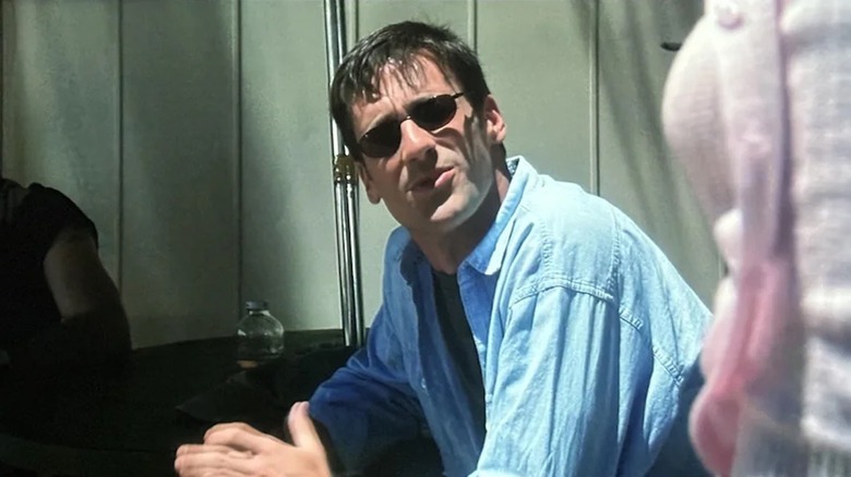 Jon Hamm looks very un-Draper-like in sunglasses and a rumpled blue button-down shirt in Space Cowboys